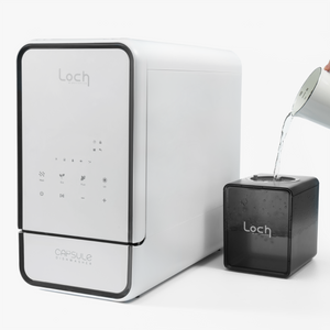Loch water dispenser with a black cube-shaped device on a white background