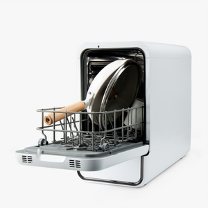 Portable dish dryer with a pan and wooden spoon inside on a white background