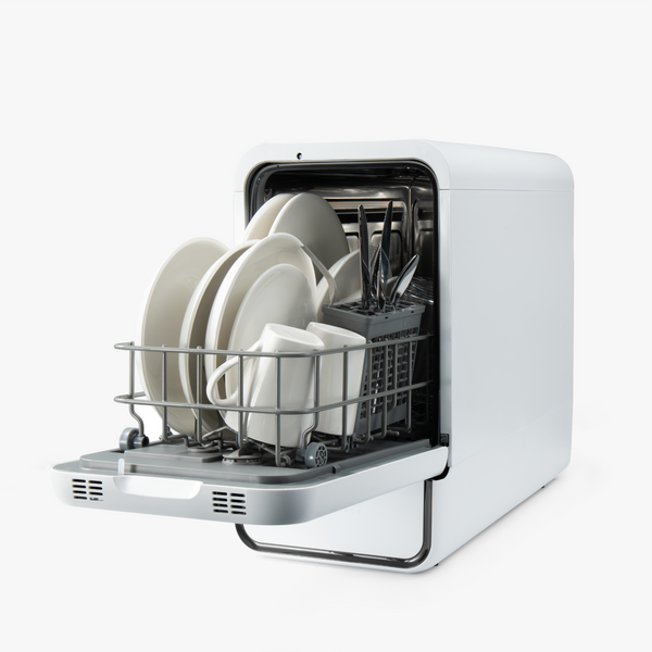 Portable dishwasher with dishes inside on a white background
