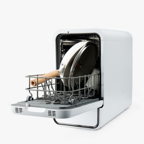 Portable dish dryer with a pan and wooden spoon inside on a white background