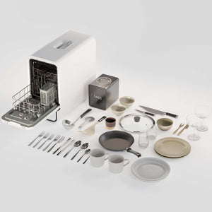 Dishwasher with clean dishes including plates, cups, and utensils on a white background